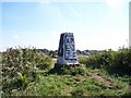 The graffiti daubed trig point on Blundell