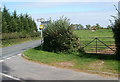 Signpost near field entrance, Usk Road