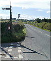 Postbox, signpost and bus stop opposite Ton Cottages, Usk Road