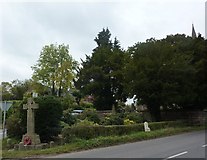 SK2849 : Memorial cross, milestone and churchyard by Peter Barr