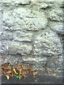 Benchmark on wall of Littlemore Road outside St James Place