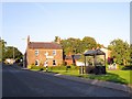 Sign post and bus shelter, Cumwhinton