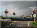 TR0929 : Train on East Bridge Road level crossing  by David Anstiss