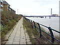 View southeast along path beside Thames towards Harrisons Wharf