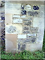 Benchmark on buttress of church of St Mary and St Peter