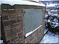 Plaque in memorial garden below former St John