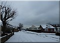 Approaching the crossroads of a snowy  Solent Road and Portsdown Avenue