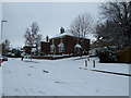 Approaching the crossroads of a snowy  Solent Road and Augustine Road