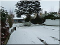 Approaching the junction of a snowy Solent Road with Drayton Lane