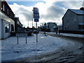 Junction of a snowy  Lower Farlington Road with  Second Avenue