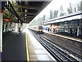 Railway station with London-bound train approaching