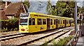 Tram 2542 in "Amey" advertising livery, by the former South Lodge of Addington Palace in 2001