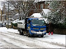 TQ0049 : A truck struggling through the snow in Epsom Road (A246) by L S Wilson