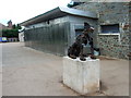 Blaise Castle Estate - dog statue with the fountain wall of the cafe in the background