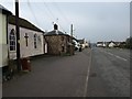 Road through Cheriton Cross, with old toll house