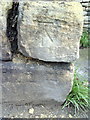 Benchmark on SE end of wall in front of Almshouses on Newland