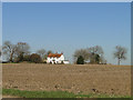 Country cottage across a ploughed field off the B1119