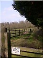 Footpath between field and woodland near Blacknest