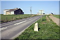 Milestone and barns beside the A417 NW of Upton