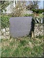 A slate commemorative stone outside the grounds of the former school, Llanddeiniolen