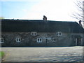 Road passes a thatched cottage in Whitehall