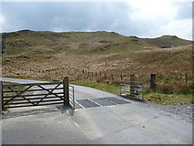 SN7386 : Gate and cattle grid on the road around Nant-y-moch Reservoir by Jeremy Bolwell