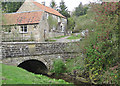 Simple stone arch bridge over Ings Beck