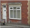 Detail of lettering above window of 1 Newport Road, Hay-on-Wye