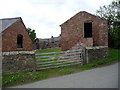 Red brick barns and outbuildings at Rake Lane