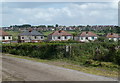 Farm track and houses by Sheffield Road