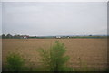 Large ploughed field by the railway line