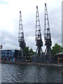 TQ3779 : Cranes on Millwall Dock by Malc McDonald