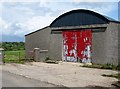 A farm shed with a red door on the Loughmoney Road