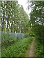 Footpath running between railway and industrial area