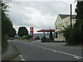 The A40 passes a garage and disused pub in Postcombe