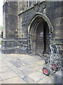 The west door of the minster and a memorial stone