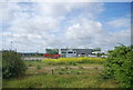 Looking across derelict land to an industrial unit, West Thurrock