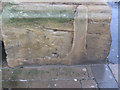 Weathered bench mark on Whitby station