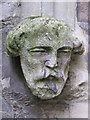 Stone head by the entrance to St. Peter