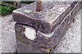 NY3059 : Benchmark on cattle grid wall at Dykesfield Farm by Roger Templeman