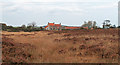 Grassy moorland with Waupley New Inn beyond