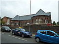 Cars passing the old school on Farley Hill