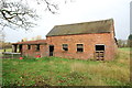 Red brick farm buildings on Church Lane, Gayton