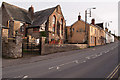 The B3233 passing the Old School House and the Plough Public House