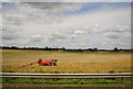 TQ5197 : Farm machinery in a large field by N Chadwick