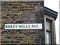 Old and modern street name plate, Bailey Wells Avenue