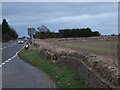 SP2611 : Broken wall in lay-by by A40 on White Hill by David Smith