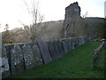 Gravestones against the church wall near Talley Abbey ruins