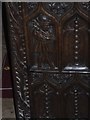 Bench end in Bickleigh Church showing wool worker