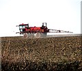 Crop spraying in field south of Session Wood, Easton